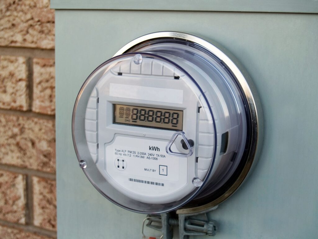 a smart electrical meter in a plastic covering mounted to a wall