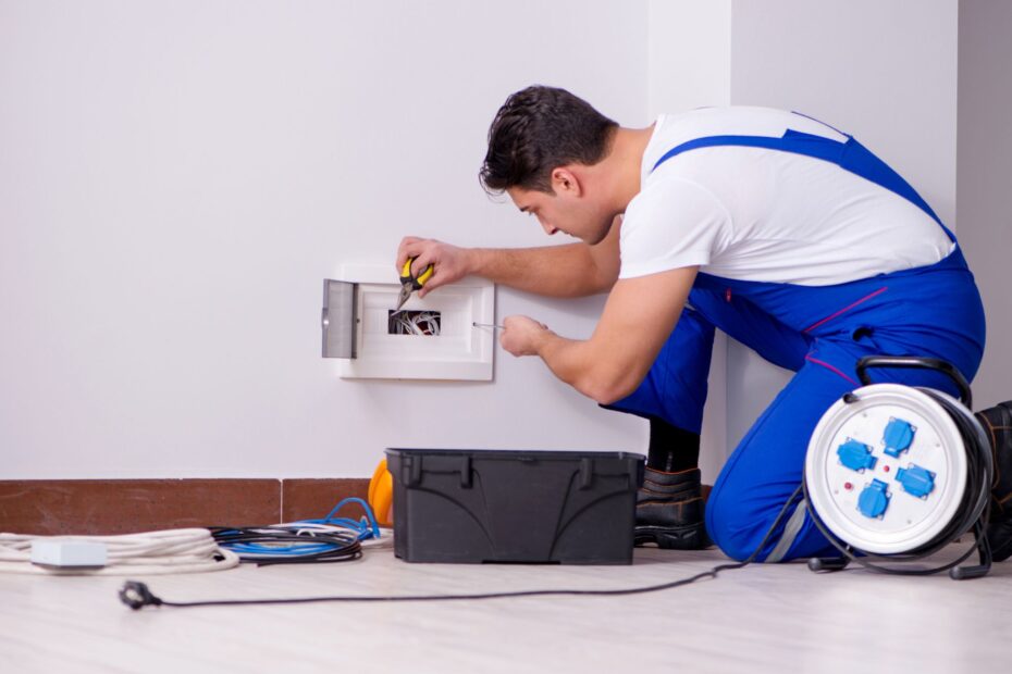 an electrician inspecting an outlet